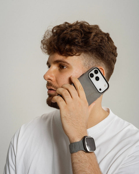Man talking on a phone with a plain background