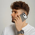 Man talking on a phone with a plain background